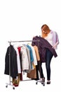 The woman choosing clothing in shop isolated on white Royalty Free Stock Photo