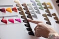 Woman Choosing Color from the Hair Color Chart For Hair Dye Concept Royalty Free Stock Photo