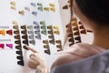 Woman Choosing Color from the Hair Color Chart  For Hair Dye Concept Royalty Free Stock Photo