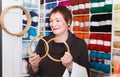 Woman choosing embroidery hoops for fancywork