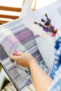 Woman choosing fabric for new curtains. Girl holds a bouquet of lavender in her hands. Fragrant lavender flowers Royalty Free Stock Photo