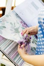 Woman choosing fabric for new curtains. Girl holds a bouquet of lavender in her hands. Fragrant lavender flowers Royalty Free Stock Photo