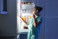 Woman choosing food from refrigerator in kitchen Royalty Free Stock Photo