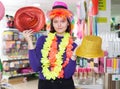 Woman choosing funny headdresses in store Royalty Free Stock Photo