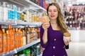 woman choosing hair shampoos and conditioners