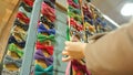 Woman choosing handmade bow-tie among huge variety at handcraft store, fashion