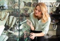 Woman choosing jewelry in glass showcase Royalty Free Stock Photo