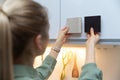 Woman choosing kitchen cabinet materials from laminate samples Royalty Free Stock Photo