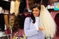 Woman choosing natural wig at specialty boutique