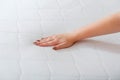 Woman choosing new mattress. Female hand Pressing Testing mattress to Check softness. Choice comfortable mattress for sleep in