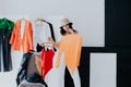 Woman choosing outfit from large wardrobe closet with stylish clothes and home stuff Royalty Free Stock Photo