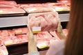 Woman choosing packed chicken meat