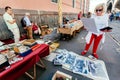 Woman choosing printed photos at antique market with old artworks, vintage decor and retro stuff Royalty Free Stock Photo