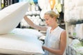 Woman choosing the right item for her apartment in a modern home furnishings store.