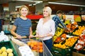 Woman choosing seasonal fruits Royalty Free Stock Photo