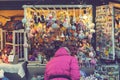 Woman choosing toys at Christmas market. woman chooses souvenirs at the Christmas market. back view. toned