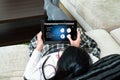 A woman is choosing type of action on tablet's smarthome applica