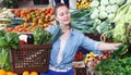 Woman is choosing vagetables with basket