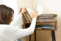 Woman choosing vinyl records at home for listening
