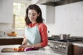 Woman chopping carrots in kitchen for Jewish passover meal Royalty Free Stock Photo