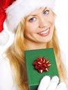 Woman in christmas clothes holding present Royalty Free Stock Photo