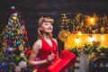 Woman in Christmas dress near the Christmas tree. Christmas preparation - luxury girl celebrating new year. Merry Royalty Free Stock Photo