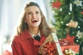 Woman with Christmas giftes looking up near Christmas tree Royalty Free Stock Photo