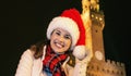 Woman in Christmas hat near Palazzo Vecchio in Florence, Italy Royalty Free Stock Photo