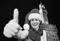 Woman in Christmas hat near Palazzo Vecchio showing thumbs up Royalty Free Stock Photo