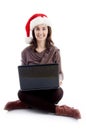 Woman in christmas hat posing with laptop Royalty Free Stock Photo