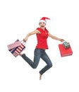 Woman in Christmas hat with shopping bags jumping Royalty Free Stock Photo