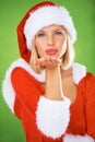 Woman, Christmas and kiss in studio portrait for holiday celebration, festive greeting or winter vacation. Female person Royalty Free Stock Photo