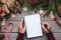 Woman Christmas letter on paper on wooden background