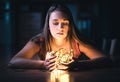 Woman with christmas light. Hope, despair and emotion. Portrait of a model with beautiful face in dark home at night.