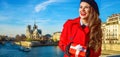 Woman with Christmas present box looking into the distance Royalty Free Stock Photo