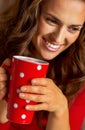 Woman in christmas red dress having cup of hot bever Royalty Free Stock Photo