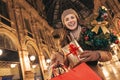 Woman with Christmas tree showing shopping bags in Milan