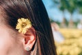 Woman chrysanthemum flower on ear