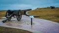 Woman at Civil War Fort standing behind a cannon