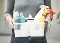 Woman, cleaner or housewife holding cleaning supplies, detergents and hygiene tools or products in a basket. Hands of a Royalty Free Stock Photo