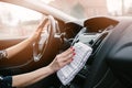 Woman cleaning car dashboard