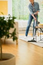 Woman cleaning carpet in house Royalty Free Stock Photo