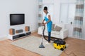 Woman Cleaning Carpet With Vacuum Cleaner Royalty Free Stock Photo