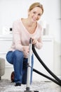 Woman cleaning carpet with vacuum cleaner Royalty Free Stock Photo