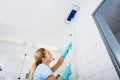 Woman Cleaning The Ceiling Of The Bathroom With Mop Royalty Free Stock Photo