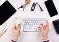 Woman cleaning a computer keyboard with an antiseptic spray