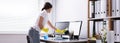 Woman Cleaning Computer In Office Royalty Free Stock Photo