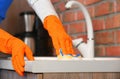 Woman cleaning counter with sponge in kitchen Royalty Free Stock Photo