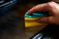 Woman cleaning dirty and greasy oven with stove in kitchen Royalty Free Stock Photo