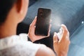 Woman Cleaning And Disinfecting Cell Phone Against Virus